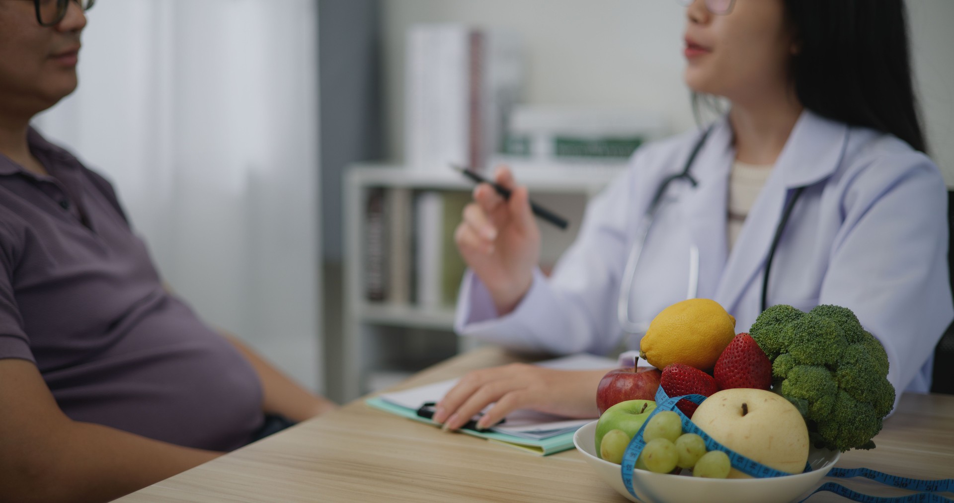 Professional nutritionist asian woman consulting fat man in weight loss clinic